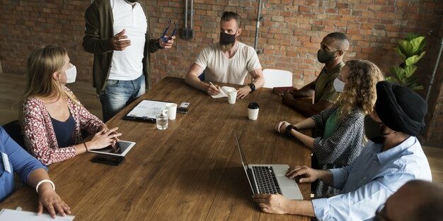 business-people-wearing-masks-coronavirus-meeting_53876-97630